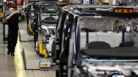 Reuters A worker walks along the TX electric taxi production line inside the LEVC (London Electric Vehicle Company) factory in Coventry, Britain,