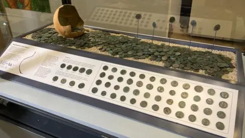 Coins on display in glass cabinet