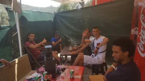 camp residents enjoy a beer together