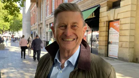 Hollie Cole/BBC Councillor Steve Allen in Peterborough city centre