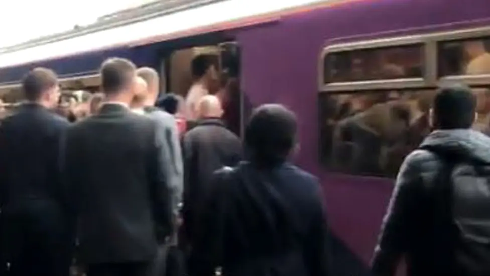 PA Media Commuters at Bolton train station trying to board a packed Northern Rail train