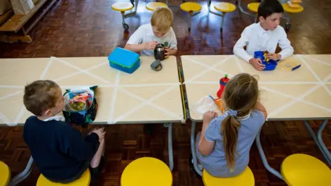 PA Media Children eating lunch in segregated positions at Kempsey Primary School in Worcester