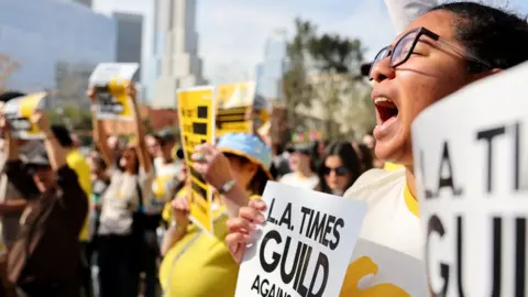 Getty Images Los Angeles Times Guild members rally outside City Hall against ‘significant’ imminent layoffs at the Los Angeles Times newspaper during a one-day walkout