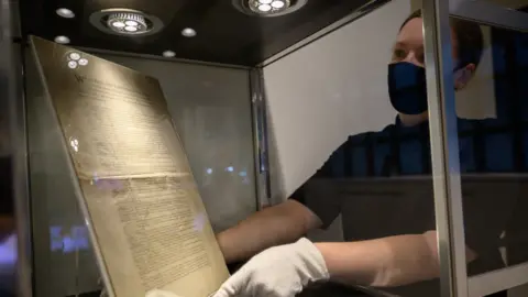 Getty Images A copy of the constitution is placed into a glass cage