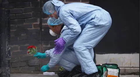Getty Images Forensic investigators at the scene of the stabbing