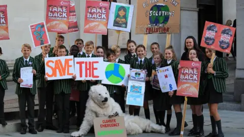 PA Media Children from Terra Nova Secondary in Cheshire attend the UK Student Climate Network's strike in Manchester