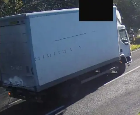 Suffolk Police The white DAF LF vehicle with "I'M HERE" written in dirt on the back