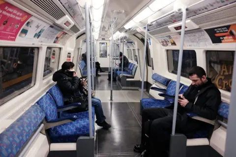 PA Media A quiet Jubilee line westbound train carriage