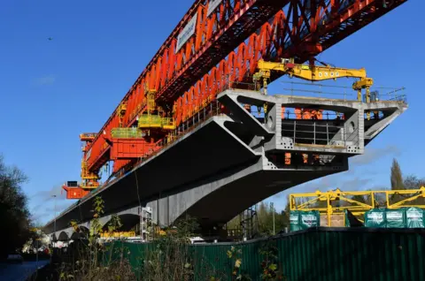 Getty Images A 700 ton bridge building machine known as a 'launch girder', drops a pre-cast concrete section into place during construction of the HS2 Colne Valley Viaduct