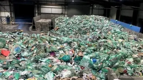 Cardiff council Green bags filled with recycling at Cardiff waste centre