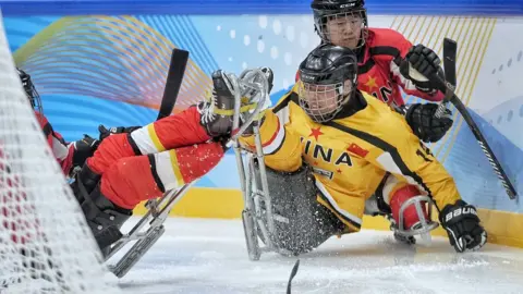 Getty Images Chinese players collide in the Para Ice Hockey test