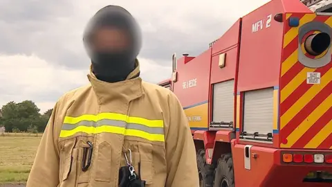 Alex Dunlop/BBC Blurred image op-sec'd (approved for use by MOD) of a senior Ukrainian military firefighter