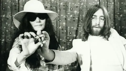 Getty Images John Lennon and Yoko Ono with acorns