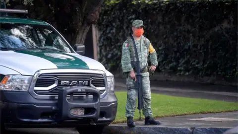 Getty Images A soldier stands guard after Mexico City's Public Security Secretary Omar Garcia Harfuch was wounded in an attacked in Mexico City, on June 26, 2020