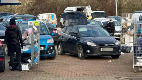 Boots of cars at the depot are open for parcels