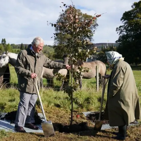 PA Media Queen Elizabeth II and then Prince Charles planting a tree