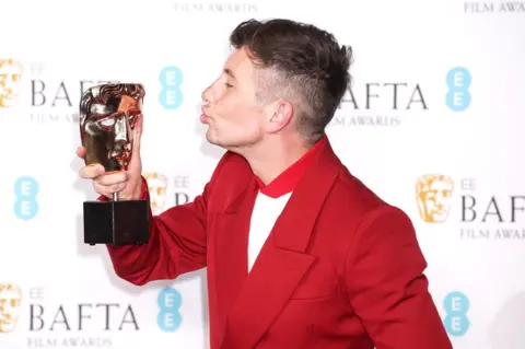 PA Media Barry Keoghan poses with his Bafta for best supporting actor