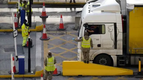 AFP Members of the Army wave a lorry driver through to the Port of Dover on Christmas Day 2020