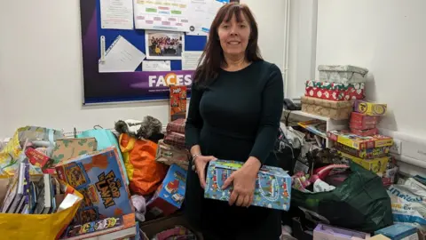 Tara Dolby/BBC Michaela Martindale, Faces chief executive officer, with donated presents