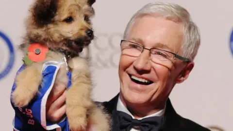 Paul O'Grady holding dog