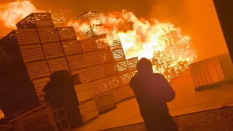 David Brennan Pallets on fire at the scene of the blaze
