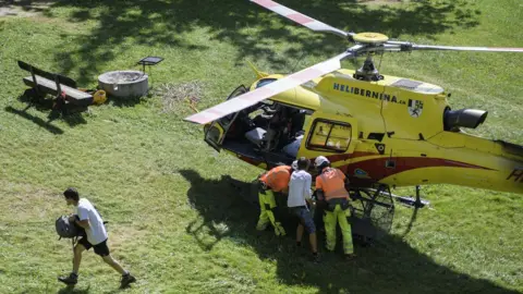 EPA A group of hikers are evacuated from a cut-off mountain hut in Bondo, Graubuenden, South Switzerland, 24 August 2017