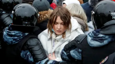 Reuters Law enforcement officers detain a woman during a rally in support of jailed Russian opposition leader Alexei Navalny in Moscow, Russia January 23, 2021