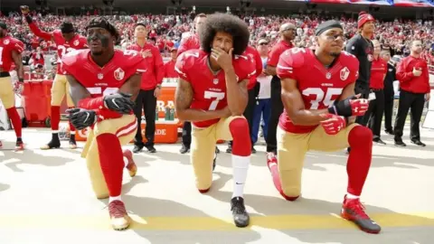 EPA Colin Kaepernick (C), Eli Harold (L), and Eric Reid (R)