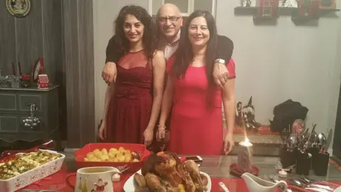 Sherry Izadi Anoosheh Ashoori (centre) with his daughter and his wife