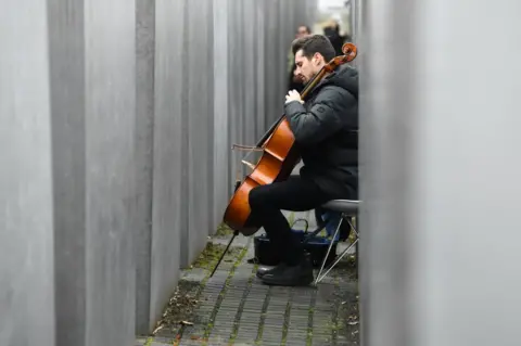 Reuters Slovenian cello Luka Sulic plays as part of a service