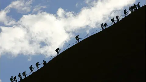 AFP Tourists climbing Uluru in 2005