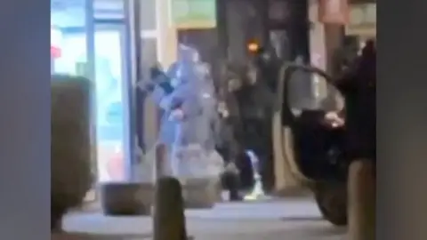 Armed police looking inside a takeaway