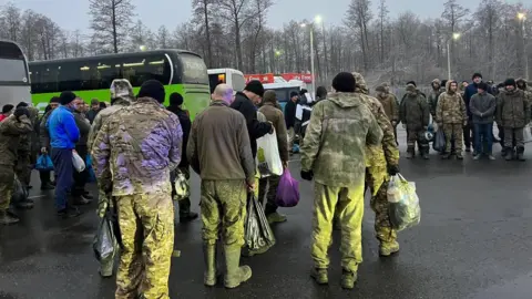 Russian Human Rights Ombudsman via Telegram Russian soldiers in uniform and winter clothing gather near buses