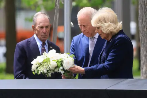 Getty Images Former New York Mayor Michael Bloomberg, chairman of the National September 11 Memorial, King Charles III and Queen Camilla attend a ceremony at the National September 11 Memorial during a state visit on April 29, 2026 in New York City. 