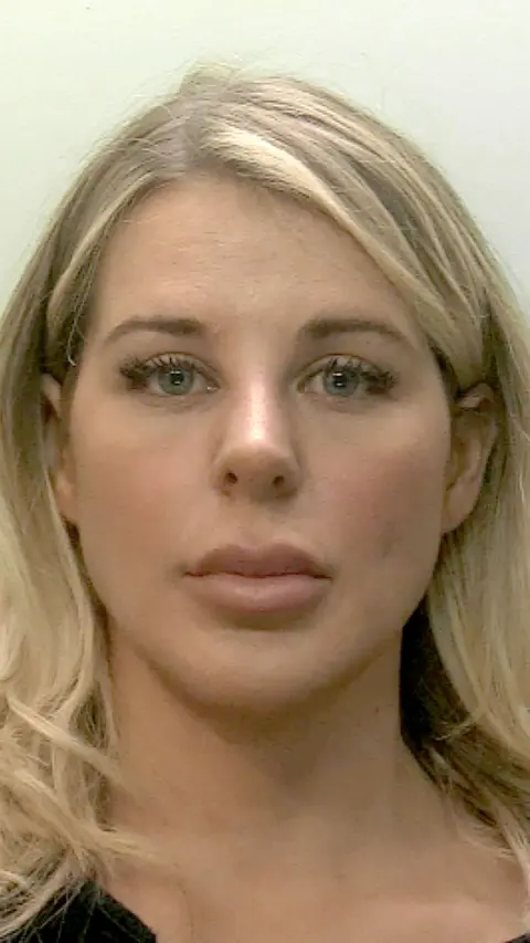 Mug shot of a woman with blonde hair