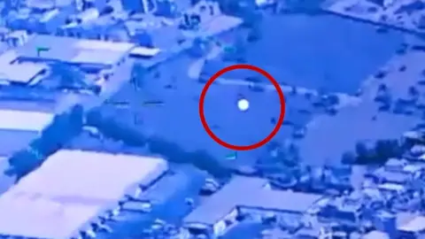 Image shows a UFO with a red circle around it.