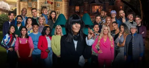 The contestants of the new series of Traitors, posing with Claudia Winkleman in front of the Scottish castle in Inverness where the competition is set