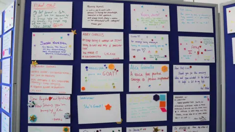 University of Bath A close up of the wall of nominations displayed on a blue notice board. One says 'keep being a woman in STEM', another says 'a voice for positive change', and another says 'thank you for the amazing ideas'. They are all written in colourful pen, with hearts and kisses drawn on them. 