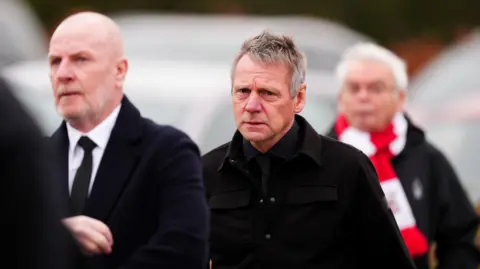 PA Media Stuart Pearce arriving at the funeral of John Robertson