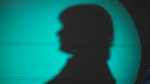 A silhouette of Lorraine (who is anonymous) 