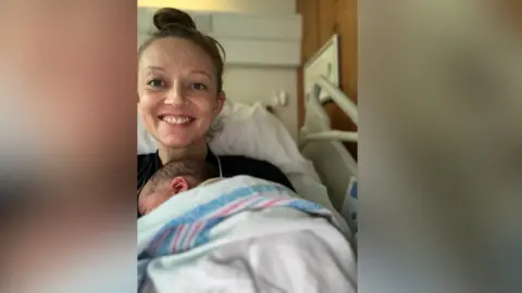 Reuters Holly Cairns, leader of Ireland's opposition Social Democrats party, poses with her new born daughter in hospital.