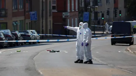Reuters Forensic police officers inside a large cordon in Nottingham after the attacks in June 2023