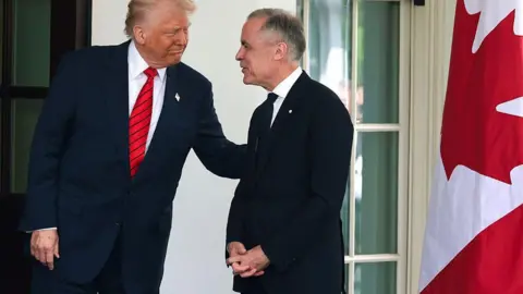 President Donald Trump greets Canadian Prime Minister Mark Carney as he arrives at the West Wing of the White House