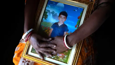 Sundarban mother holding image of her drowned son