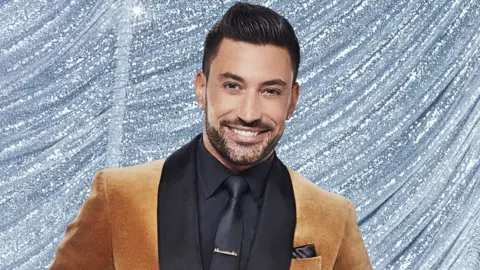 Giovanni Pernice in a brown and black suit
