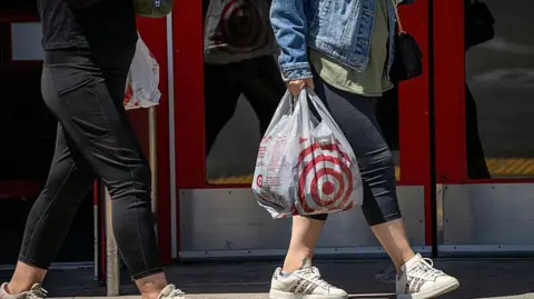 Shoppers carry shopping bags at a Target store in Pleasant Hill, California, US.