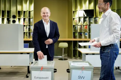 German Chancellor Olaf Scholz casts his vote for the European elections and local elections at a polling station on June 09, 2024