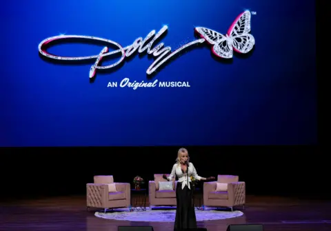 George Walker IV/AP Dolly Parton speaks during a news conference for her show Dolly: An Original Musical, Tuesday, Jan. 28, 2025, in Nashville, . 