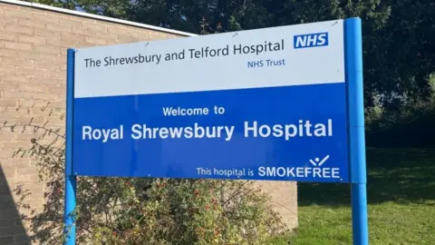 BBC A large blue sign which reads Royal Shrewsbury Hospital