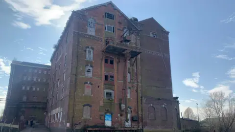 Carmelo Garcia The former Borough Flour Mills building. It's a red-brick building with boarded up windows.